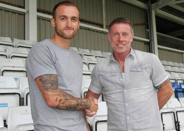 Hartlepool United boss Craig Hignett welcomes Lewis Alessandra to Victoria Park. Pictures courtesy of Hartlepool United