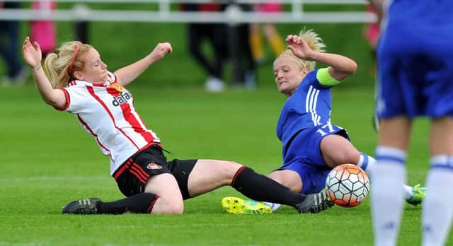 Rachel Furness slides into a tackle with Chelsea skipper Katie Chapman (right). Picture by FRANK REID