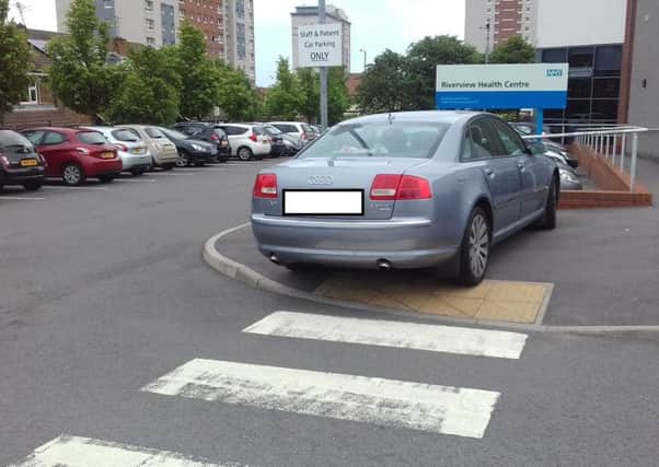 Audi car parked over part of a ramped area for wheelchairs users at Riverview Health Centre, in Hendon, on Tuesday, June 28.