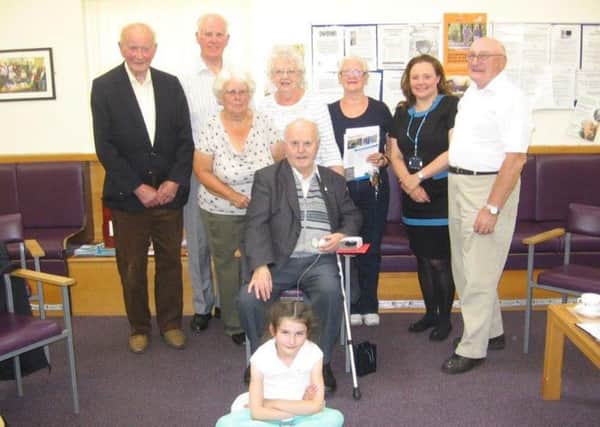 Tom Forsyth, seated, practice manager of Church View Medical Centre, with patients.