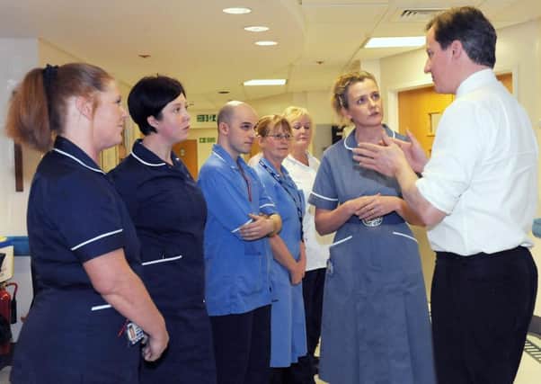 Former Prime Minister David Cameron talking to NHS staff