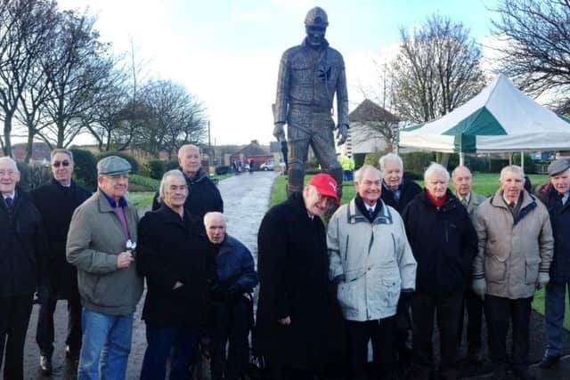 Former miners gather at the feet of Marra after he was unveiled to the ex-pit community.