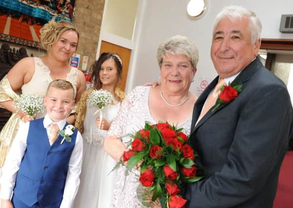 Pat and Tom Colledge celebrate their Golden Wedding Anniversary by renewing their wedding vows, with grandchildren Jessica Jackson, Ameila Donaldson and Harry Laing.