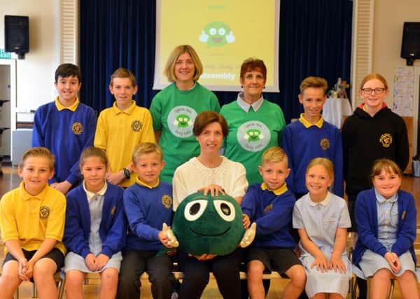 The assembly event at Our Lady Queen of Peace Primary School.
 Volunteers Amanda McMabola, back, left, and Susan Evans are pictured with pupils and NSPCC area co-ordinator Christine Danby-Platt.