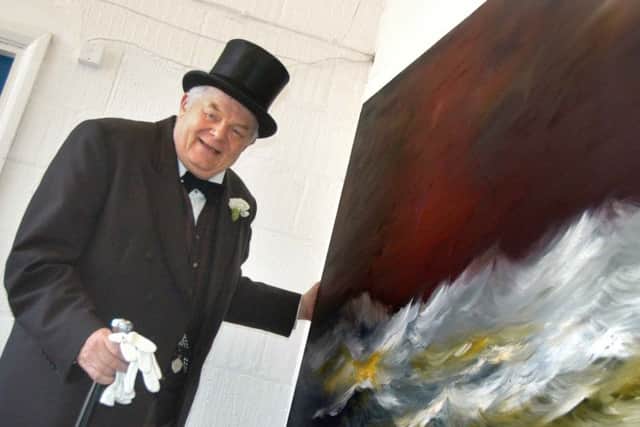Brian Moore with the painting he donated to the Adelaide appeal