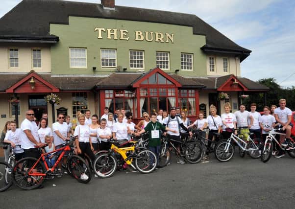 Cyclists and supporters pictured outside The Burn pub before setting off on the bike ride.
