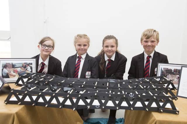 Pupils Sophie Shaw, Layla Wind, Olivia Fairweather and Jayden Thompson, all Year 5, proudly show off their model bridge.