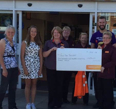 Members of Sainsbury's Fulwell hand over a cheque for nearly Â£4,300 to Pawz For Thought.