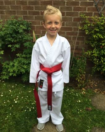 Alfie  Rhodes who double graded to achieve his red belt.