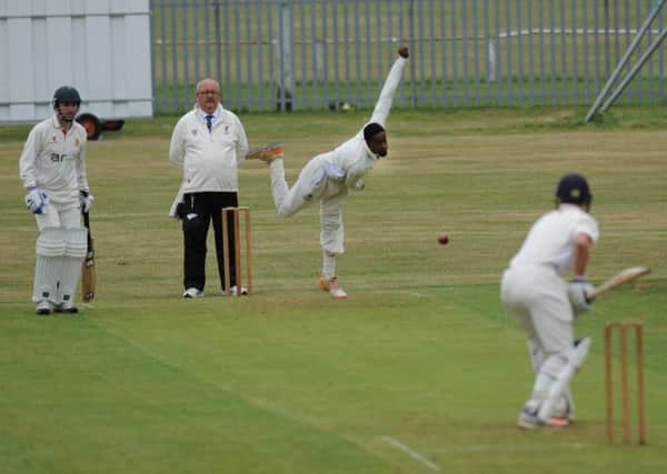 Murton bowler Phumizile Yiba powers in to test Littletown batsman Sam Harris.
