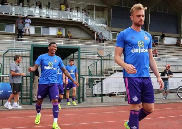Jan Kirchhoff (right) and Patrick van Aanholt run onto the pitch in Evian last night ahead of Sunderland's 3-2 friendly success against Dijon