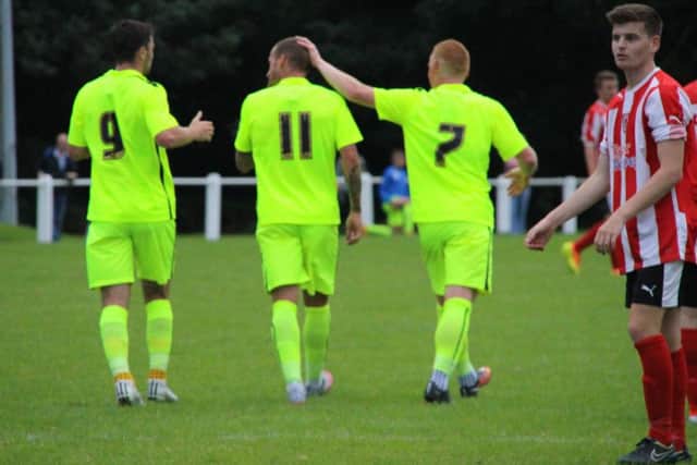 Padraig Amond (left) and Michael Woods (right) congratulate Lewis Alessandra on his first goal. Picture: HUFC
