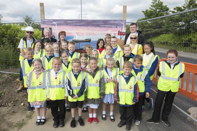 Pupils and teachers from Castletown Primary School show off one of their pieces of art with Sunderland City Council deputy leader Coun Harry Trueman, FVBs Brigid McGuigan and headteacher Joan Lumsdon.