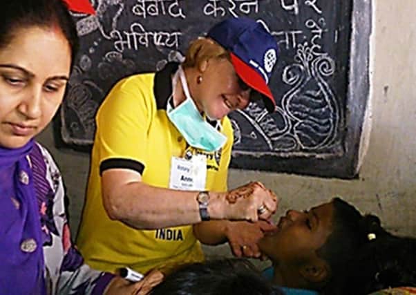 Anne Sadler immunising an Indian child against Polio.