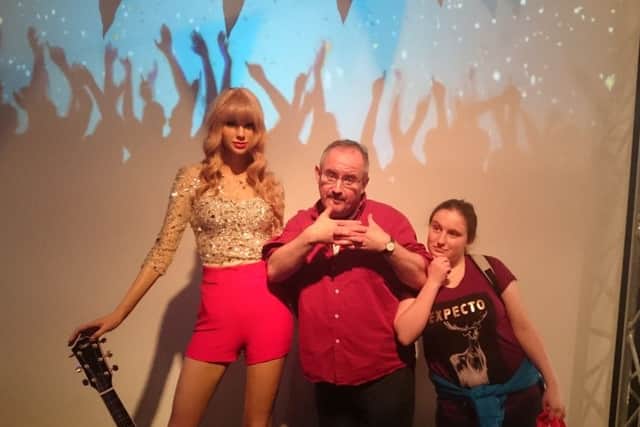 Taylor Swift has her photo taken with Kevin and Ellie.