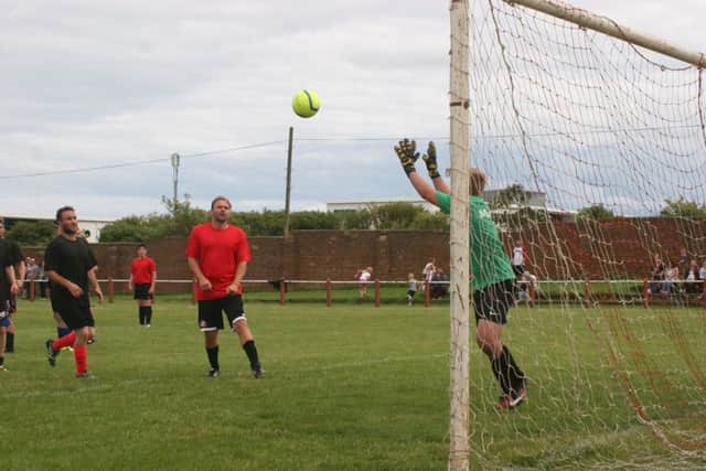 Former Sunderland player Michael Proctor and boxer Glenn Foot watch on as a save is made at the match for Megan Bell.