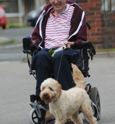 Falstone Manor Care Home resident Graeme Barker, takes resident dog Bailey for a walk.