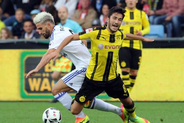 Nuri Sahin of Dortmund goes down under challenge from Sunderland's Fabio Borini
