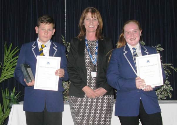 Chairman of Governors, Julie Kelly, with students, Josh Rooney and Rebecca Wilkinson, and their awards for outstanding commitment to
learning across the curriculum.