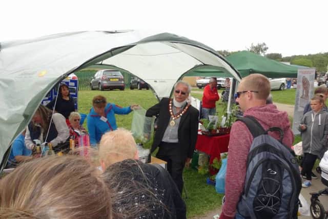 The Mayor of Hetton at the Friends of Hetton Lyons Prk stall drawing the raffle tickets.