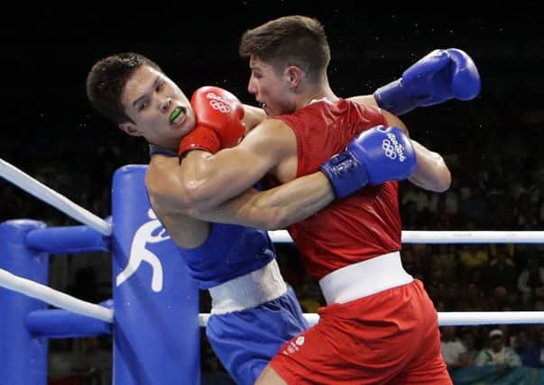 Josh Kelly (red) battles against Kazakhstan's Daniyar Yeleussinov last night