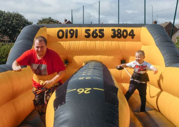 Father v son, Craig and Max (7) of Ryhope, on one of the games at Ryhope Carnival on Saturday.