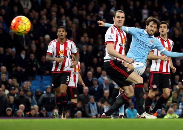 Patrick van Aanholt, John O'Shea and Jordi Gomez can only look on as David Silva fires in a shot for Manchester City in last season's Boxing Day clash at the Etihad