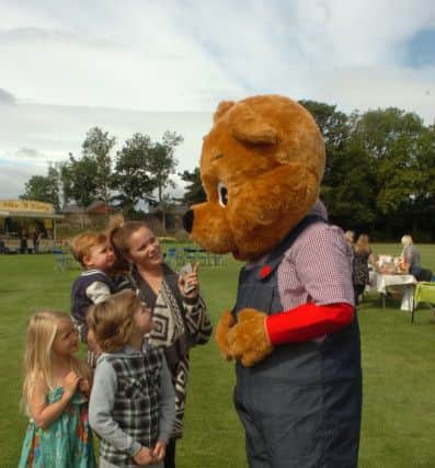 Meeeting Oakley the Bear are Louise Blakie with son Lewis (9), daughter Lily (6) and nephew Harry Longstaff (1) at the Grace House Fun day at Wearmouth CW, Thompson Road, Sunderland.
