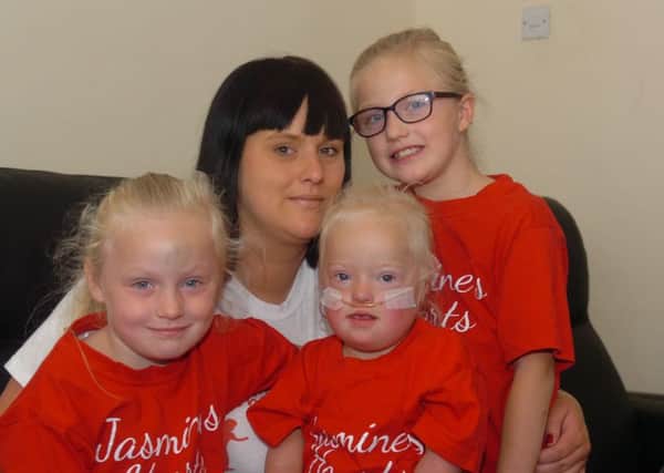 Jasmine Purvis, of Canon Cockin Stret, Sunderland, with mum Jamie and sisters Jessie (5) and Jodie (8)