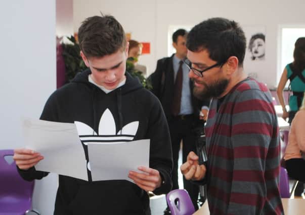 Student James Carney being congratulated by Southmoor Academy's head of sixth form, Sammy Wright, on A-level day.