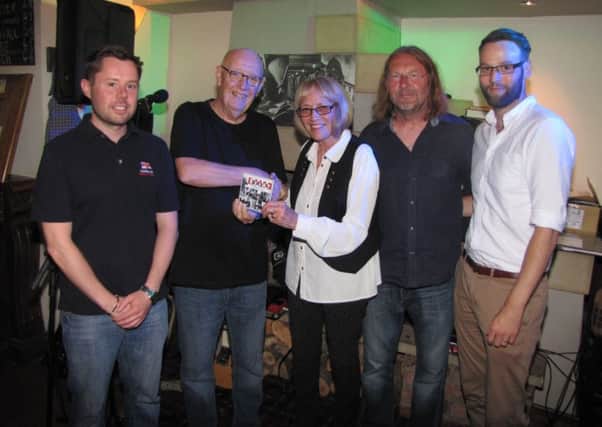 Ann and Kris Cantle, Andrew's mam and brother, are presented with a copy of the CD by George Shovlin and George Lamb alongside Sunderland RNLI volunteer Andy McGill.