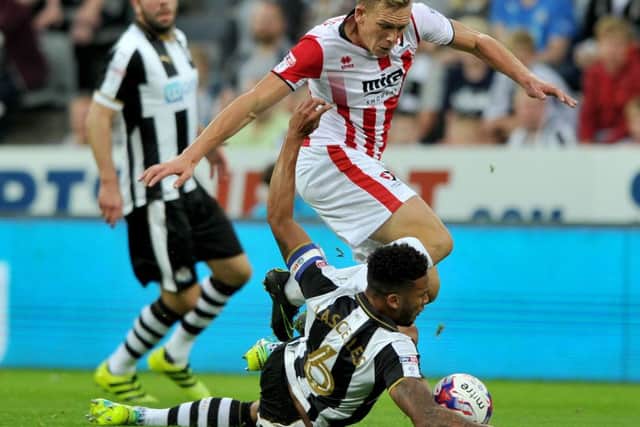 Newcastle defender Jamaal Lascelles goes to ground to try to stop Cheltenham last night. Picture by Frank Reid