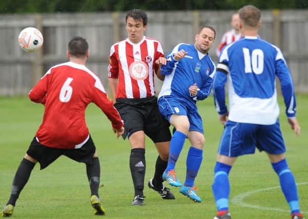 Sunderland West End (red and white) take on Wearside League rivals Jarrow.