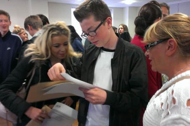 Jake Cheetham opens his results as friend Chloe Wallace and head of English Renee O'Brien look on.