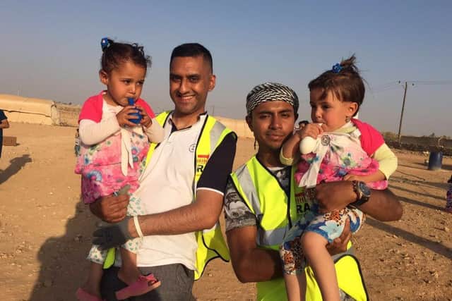 Taz Maqsood and Monir Ahmed with twins during their trip to the Jordan camps which are helping people flee Syria.