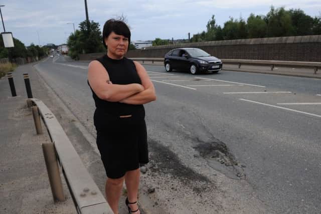 Driving instructor Lindsay Burns with the pot hole on Pallion New Road, Sunderland.