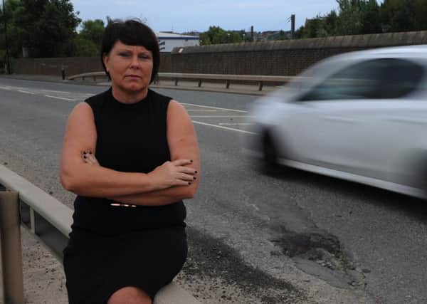 Driving instructor Lindsay Burns with the pot hole on Pallion New Road, Sunderland.