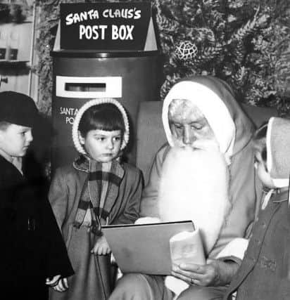 Ann Rawling is next in line to see Santa Claus at Joplings in 1960.
