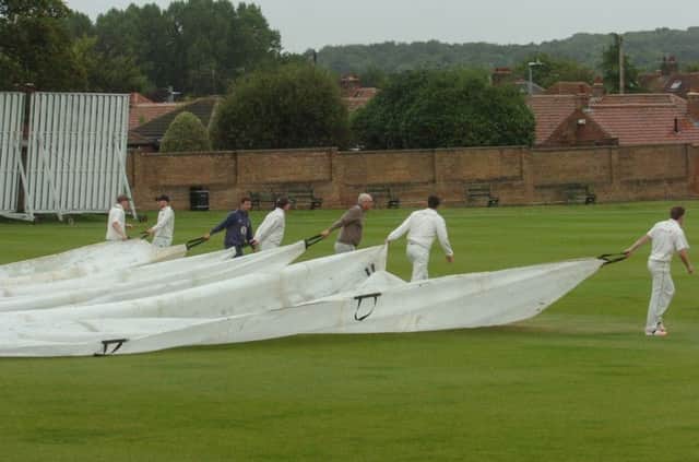 Players help groundstaff put on the covers after rain stopped the match between Chester-le-Street and Durham Academy on Saturday after just nine overs were bowled.