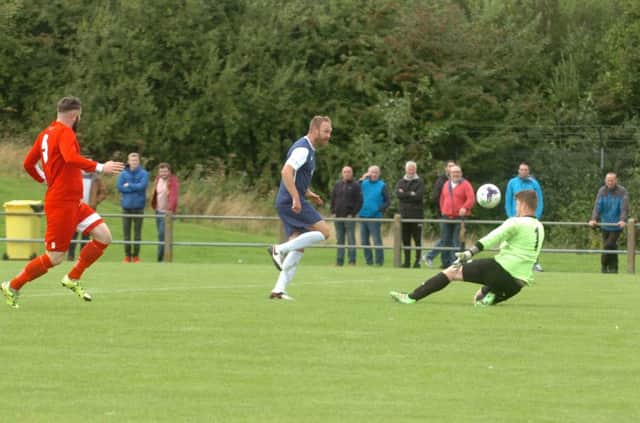 Paul Connor chips home for Shildon's fourth goal in Saturday's FA Cup win at Washington