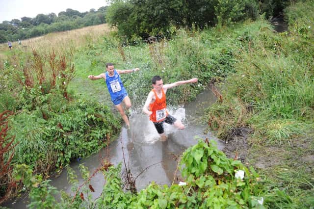 Sunderland Harrier Michael Barker hunts down Durham City Harriers as the top two cross Gilley Law stream in the Farringdon Cross Country