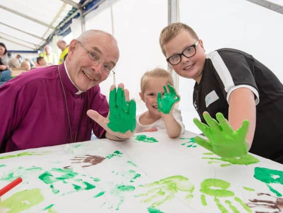 Bishop Mark gets messy with children and families thinking about hand printing to symbolise Friends of Jesus.