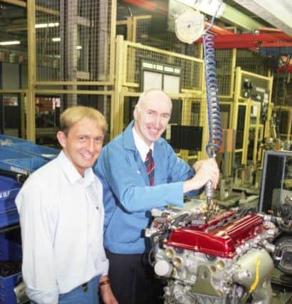 Echo business editor Ray Nicholls (right) puts the finshing touches to the plant's millionth engine in July 1995.