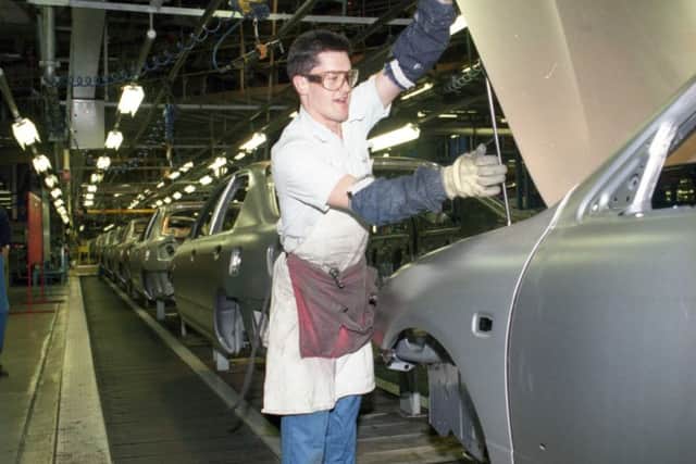Working on a car in the production line in October 1996