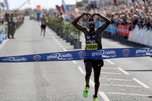 Mo Farah crosses the Great North Run finish line in trademark style. Pic: PA.
