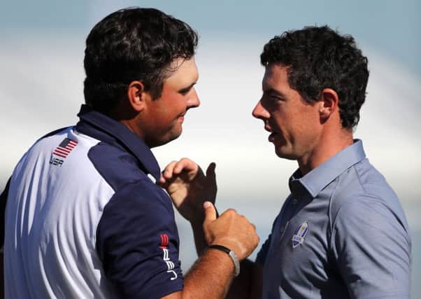 USA's Patrick Reed and Europe's Rory McIlroy shake hands