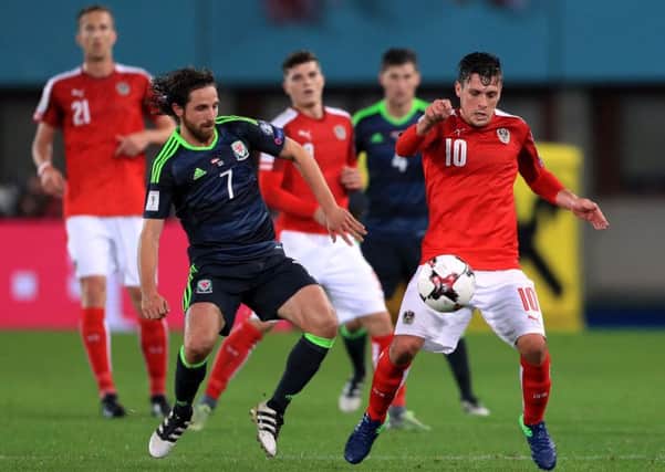 Austria's Zlatko Junuzovic (10) battles for the ball with Wales midfielder Joe Allen