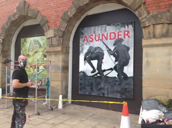 Artist Frank Styles created a new piece of work on the Old Fire Station to mark the premier of Asunder.