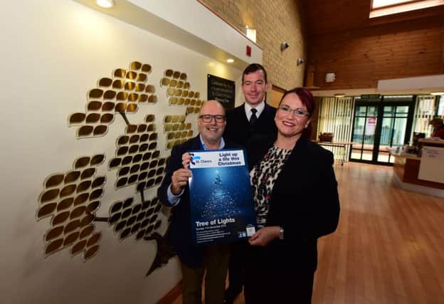 Launch of the St Clare's Hospice annual Tree of Light fundraiser with l-r David Hall Chief Exec. of the Hospice, Mark Bolton Principle Funeral Director Co-op Funeralcare and Dawn Noble Manager Co-op Funeracare.