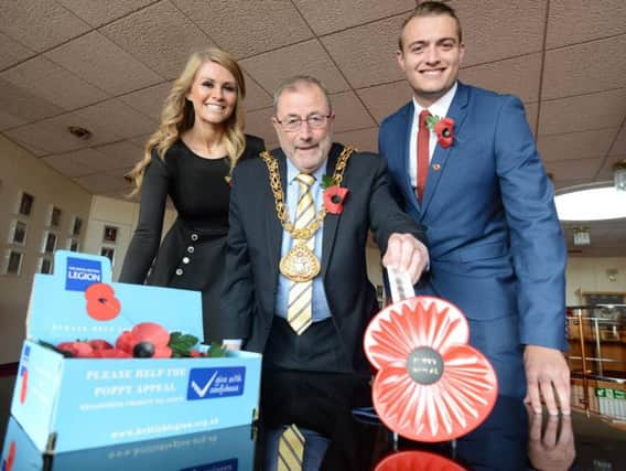 British Legion Poppy Appeal volunteers Jade Murphy and Jake Pattison pictured with the Mayor of Sunderland, Coun Alan Emerson, buying the symbolic 'first Poppy' on behalf of the people on Sunderland, to help launch this year's fundraising appeal.